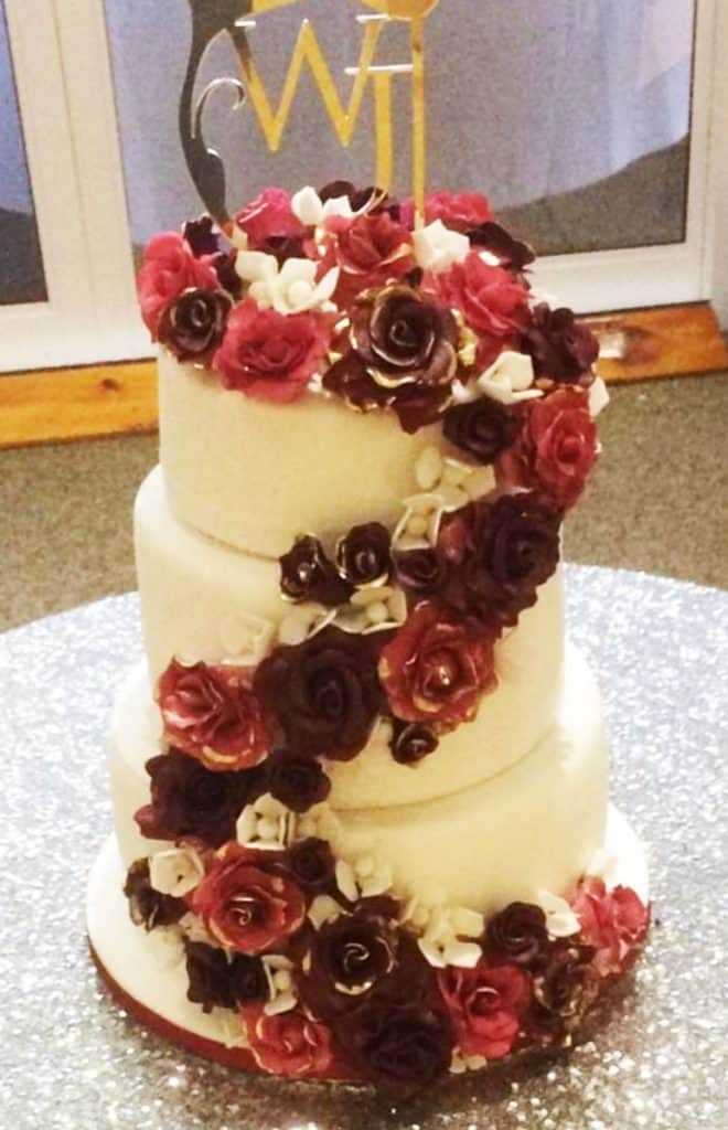 White wedding cake with burgundy sugar flowers in Howick KZN Midlands